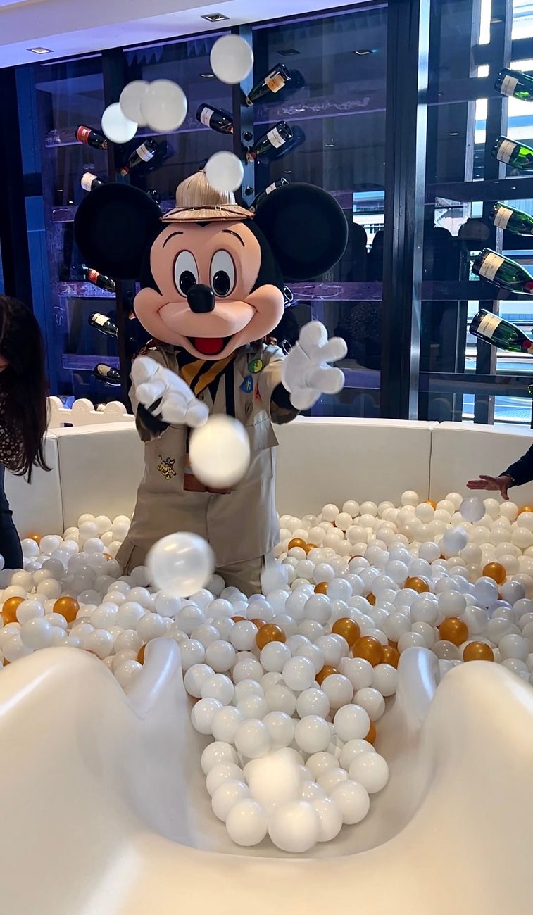 Costumed character in a styled ball pit