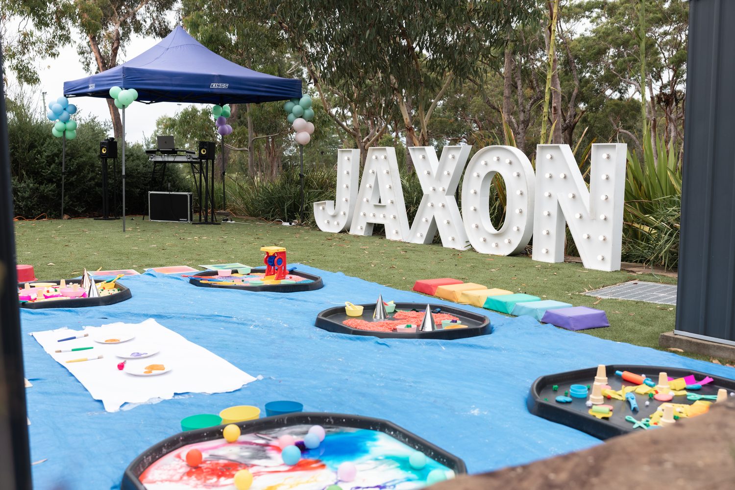 Outdoor children's party with marquee letters and balloon garland
