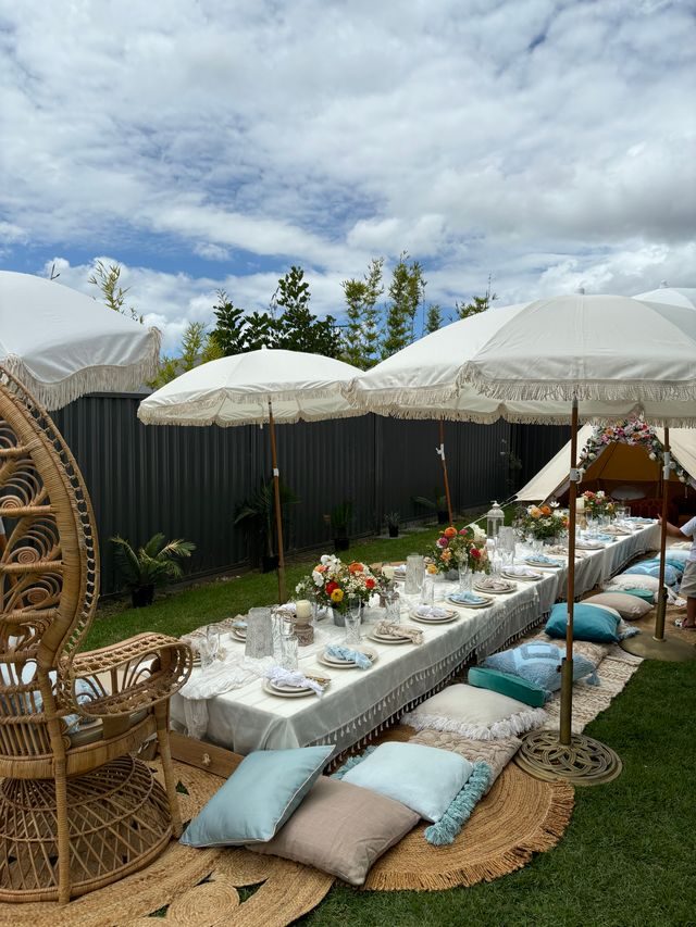 Boho luxe picnic with umbrellas and cushions